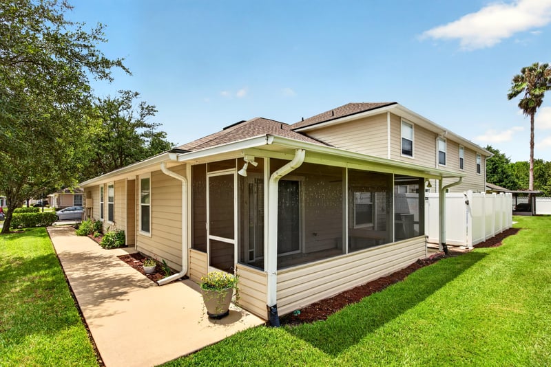 Back exterior with screened porch and patio at 605 N Covered Bridge Rd, Jacksonville, FL