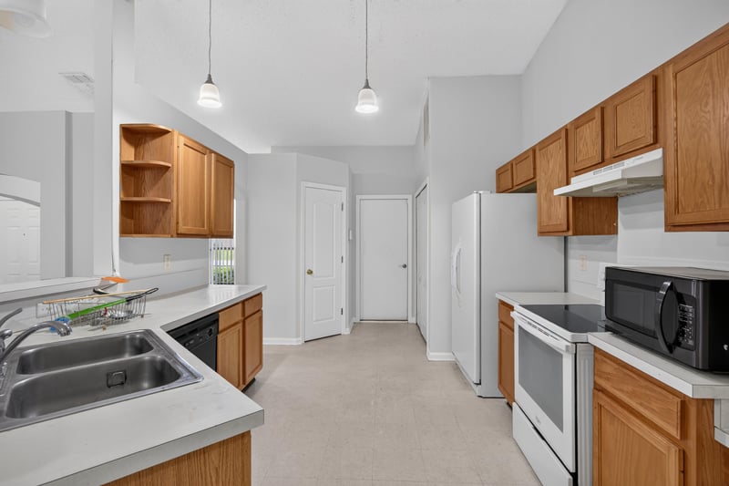 Kitchen with oak cabinets and sink at 9691 Nelson Forks Dr, Jacksonville, FL 32222