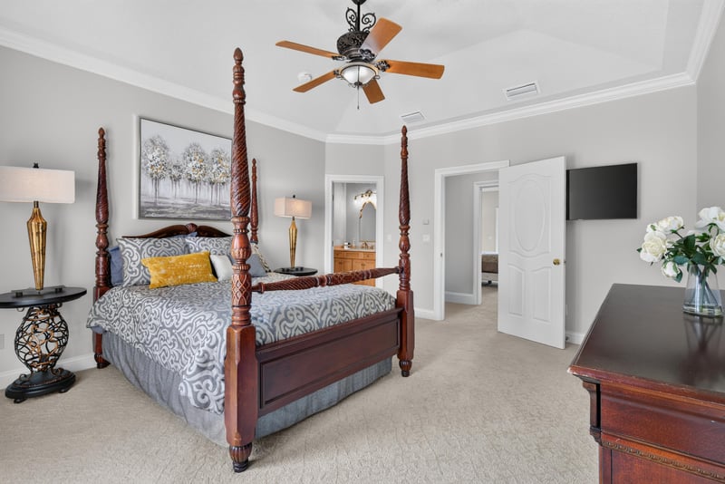 Bedroom with wood bed frame and wall-mounted TV at 344 Broward Rd, Jacksonville, FL