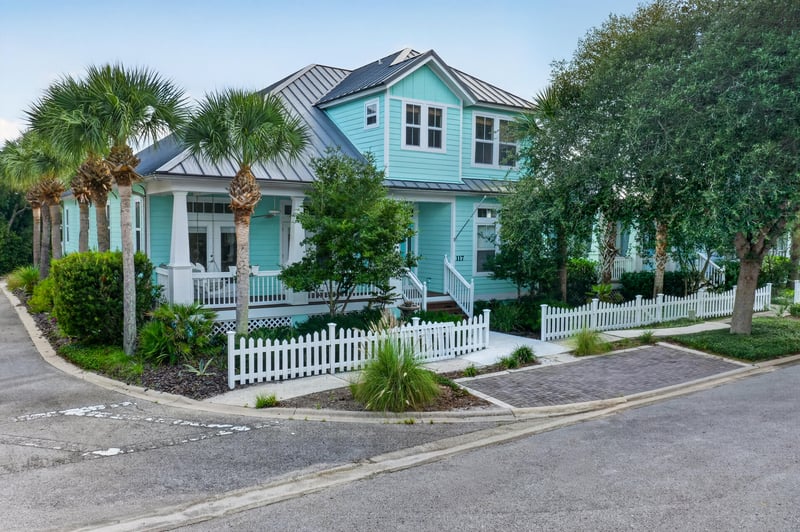 Front exterior with metal roof and palm trees at 117 Island Cottage Way, St. Augustine, FL 32080