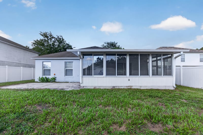 Screened back porch and yard at day-to-dusk at 1845 Saga Ct, Middleburg, FL