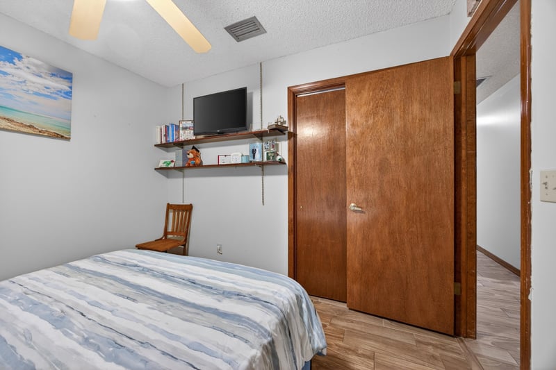 Bedroom with wall shelf and wood door at 981 Marble Ridge Dr, Orange Park, FL 32065