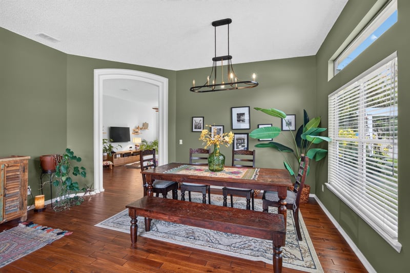 Dining room with chandelier and wood floors at 1820 Burgess Hill Dr E, Jacksonville, FL