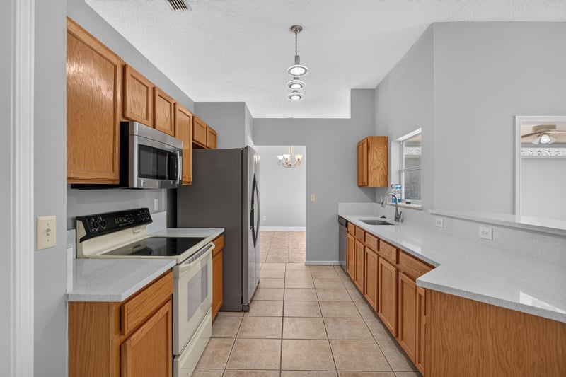 Kitchen with range and tile floor at 9256 Dale View Ln W, Jacksonville, FL 32225