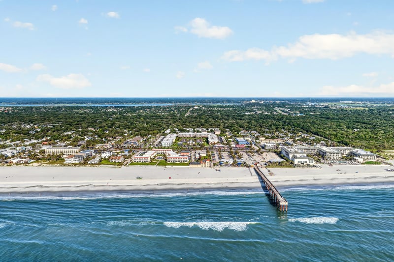 Aerial view of the beach and pier along the coast in St. Augustine, FL