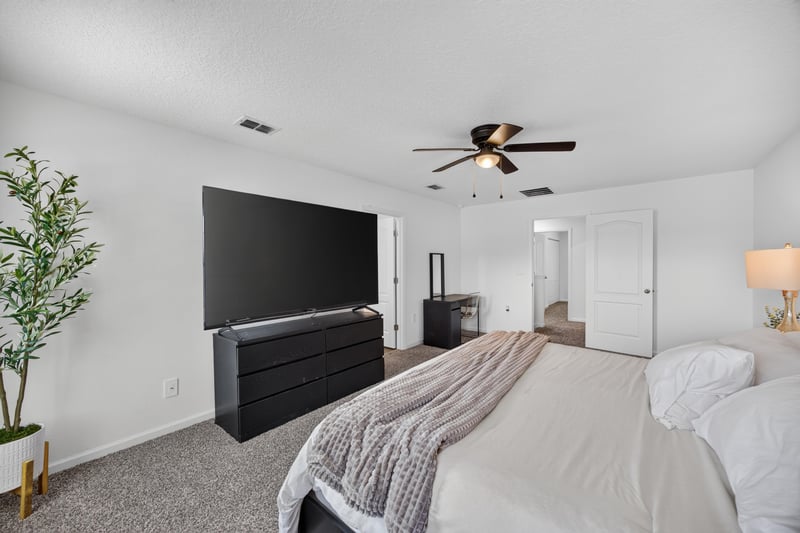Bedroom with bed and dresser at 65255 Frst Glen Ln, Yulee, FL 32097
