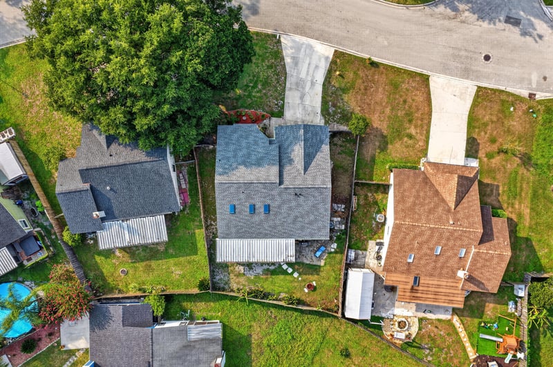 Aerial backyard view with neighboring rooftops at 13020 Medford Ln, Jacksonville, FL 32225