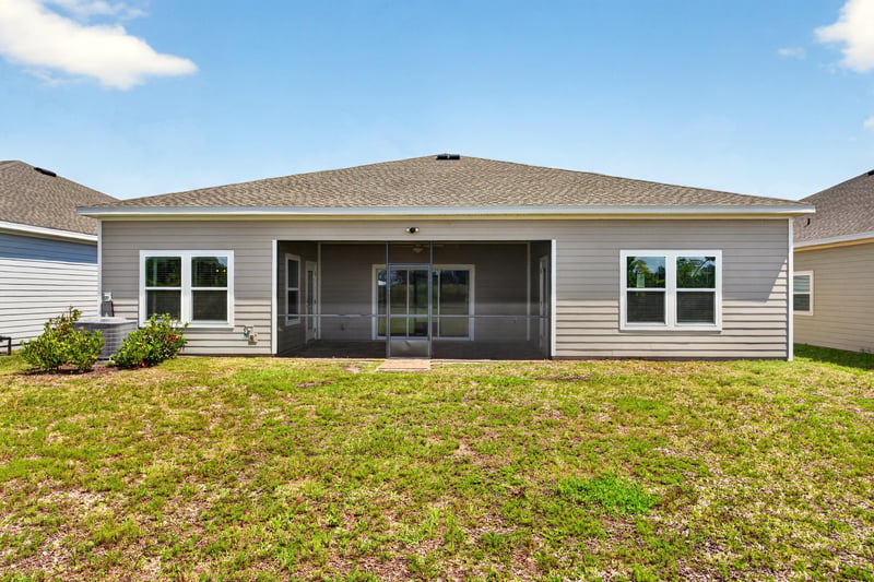 Rear exterior with screened porch at 9942 Lovage Ln, Jacksonville, FL 32219