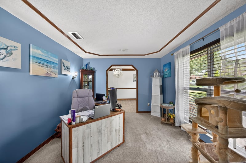 Office space with built-in desk and blue walls at 981 Marble Ridge Dr, Orange Park, FL 32065
