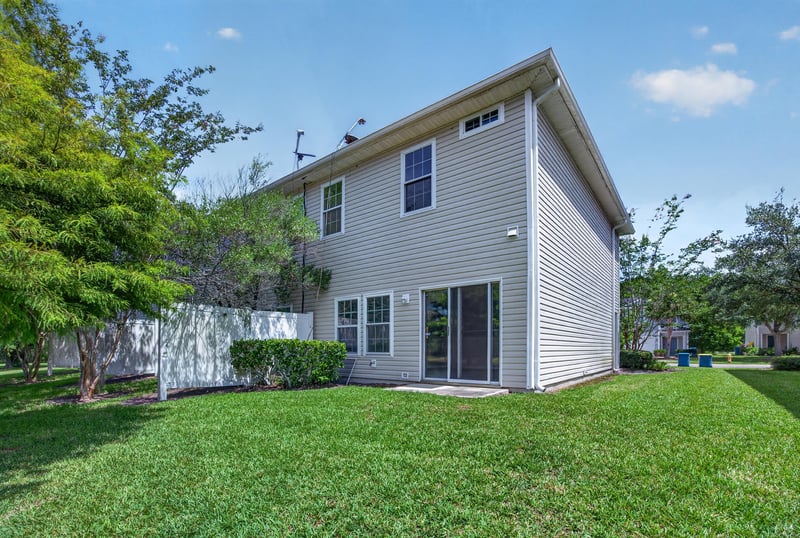 Backyard with grass and side exterior view at 1572 Biscayne Bay Dr, Jacksonville, FL 32218