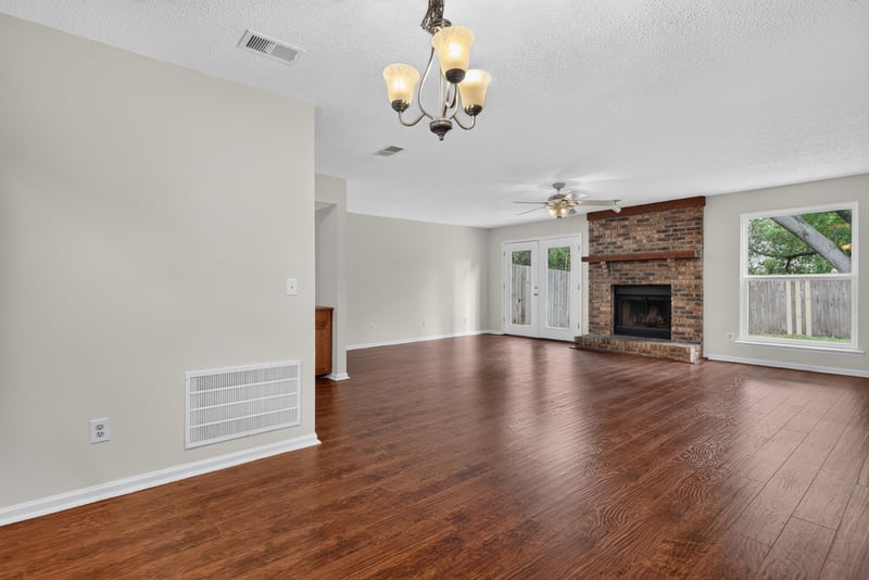 Living room with fireplace and chandelier at 4427 Millstone Ct, Jacksonville, FL