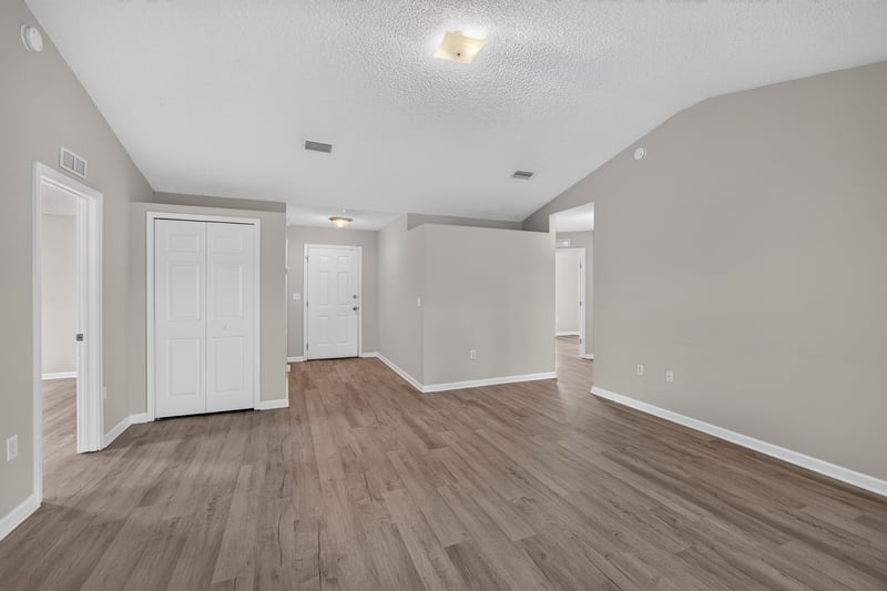 Living and dining area with closet doors at 8519 Blazing Star Ct, Jacksonville, FL 32210