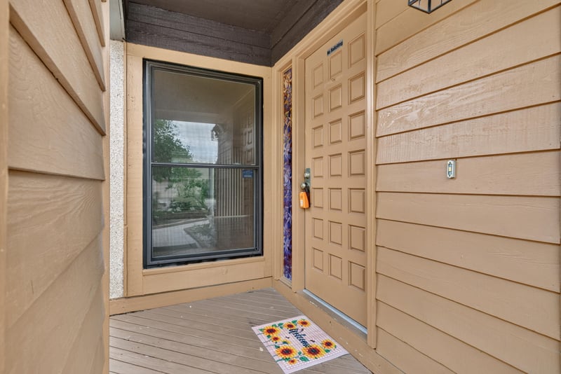 Front entry door with wood paneled wall at 3515 Cormorant Branch Ct, Jacksonville, FL