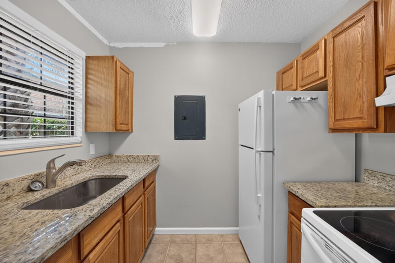 Kitchen with granite counters and refrigerator at 2719 Trollie Ln