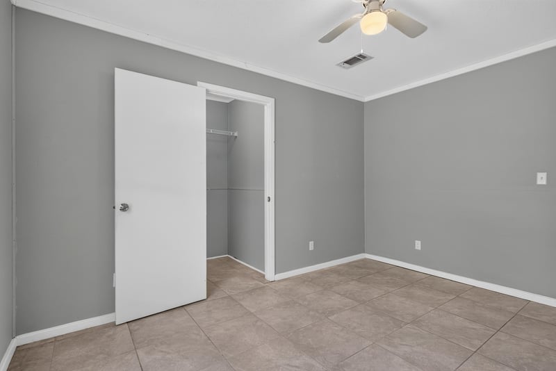 Empty bedroom with closet door at 2549 Snapdragon Ave, Middleburg, FL 32068