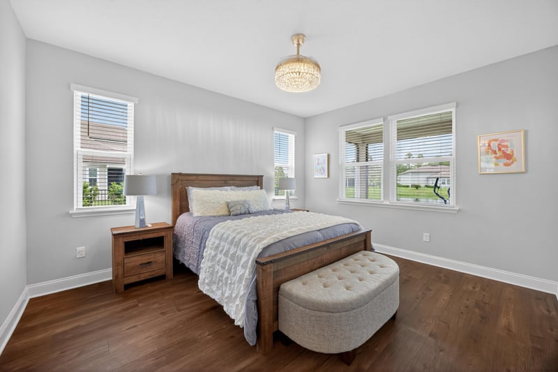 Bedroom with wood floors and ottoman bench at 85491 Fall River Pkwy, Fernandina Beach, FL 32034