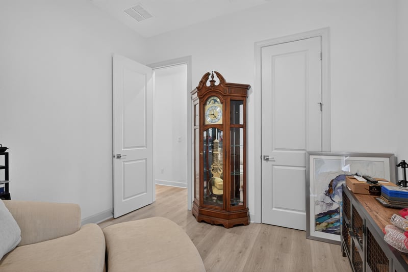 Hallway with grandfather clock and doorways at 785 Back Creek Dr, St. Augustine, FL 32092