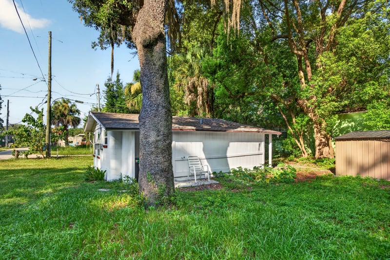 Side yard with shed and trees at 4951 Halls Dr