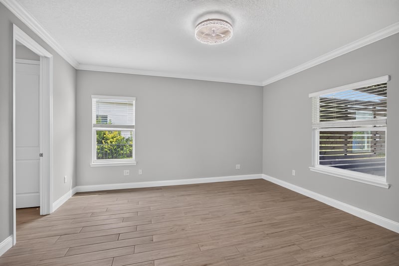 Primary bedroom with two windows at 91 Tilloo Ct, St. Johns, FL