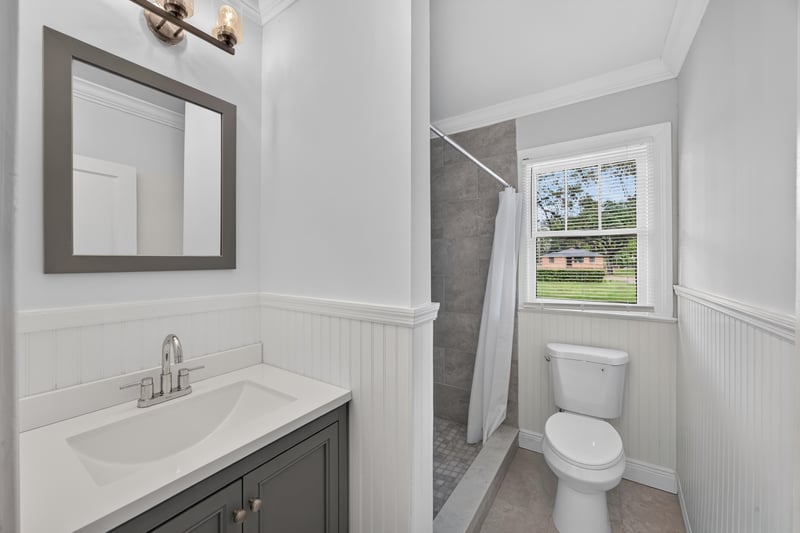 Bathroom collage with vanity mirror, toilet and window at 316 W 41st St, Jacksonville, FL 32206
