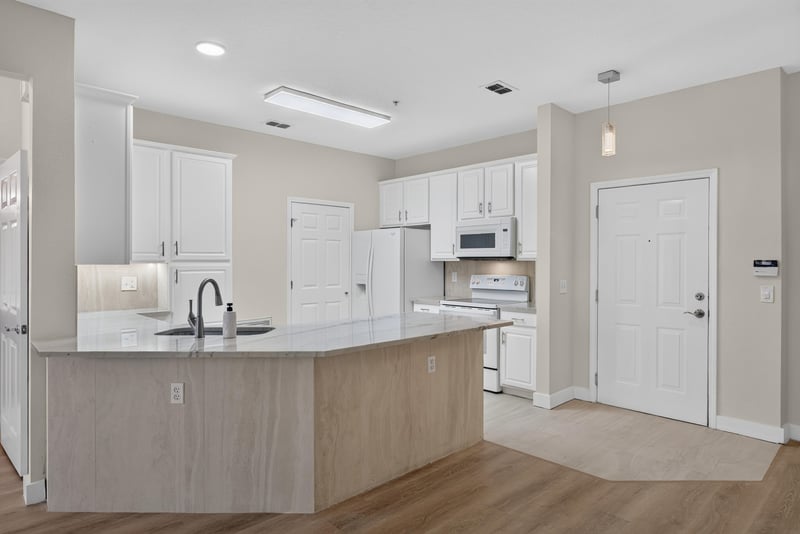 Kitchen with island and white appliances at 11251 Campfield Dr unit 1202, Jacksonville, FL 32256