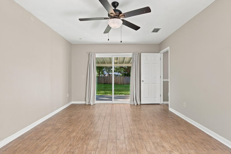 Bedroom interior view with sliding door to the backyard, photographed by Megapixeler on Crosby Ln, Orange Park