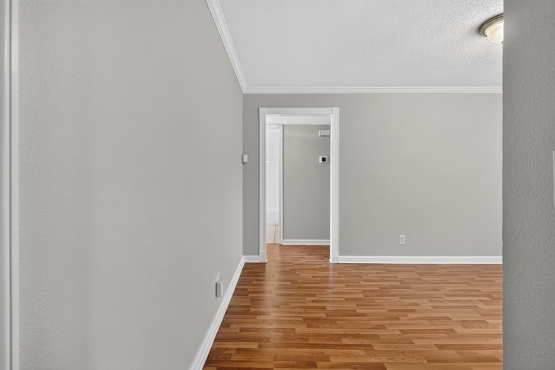 Empty room with wood laminate floor and doorway at 3866 Campenero Ct unit 6, Jacksonville, FL 32217