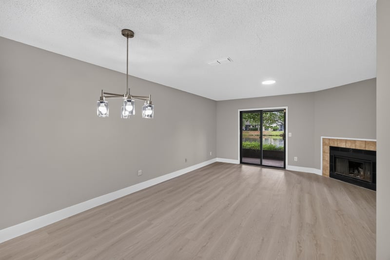 Empty living room with fireplace and sliding glass door at 3801 Crown Point Rd, Jacksonville, FL 32257