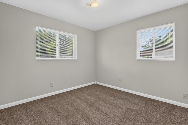 Carpeted bedroom with windows at 2618 Arlex Dr E, Jacksonville, FL
