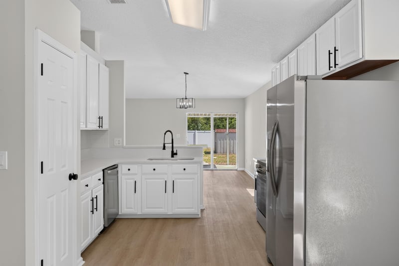 Kitchen with white cabinets and stainless refrigerator at 224 Pine Arbor Cir, St. Augustine, FL 32084