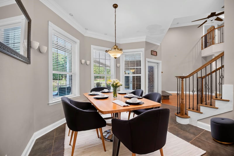 Breakfast nook staged with table and staircase view at 1735 Hagans Ridge Ct
