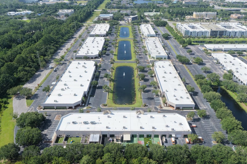 Aerial view of office buildings with central pond at 10550 Deerwood Park Blvd, Jacksonville, FL 32256