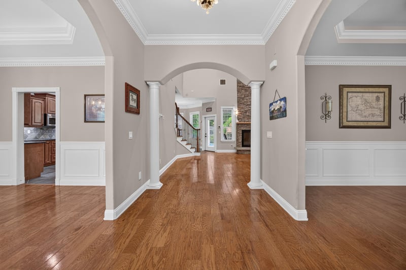 Entry hallway with hardwood floors and arched openings at 1735 Hagans Ridge Ct