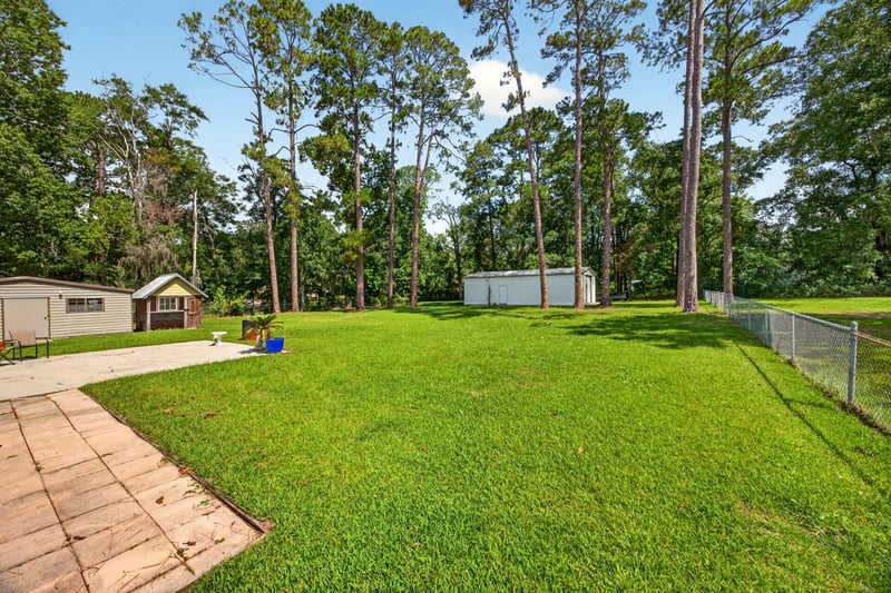 Side yard with walkway and shed in the distance at 5843 Ovella Rd, Jacksonville, FL 32244