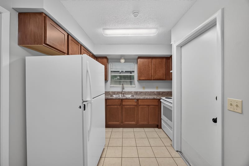 Kitchen with white refrigerator and wood cabinets at 12351 Condor Dr