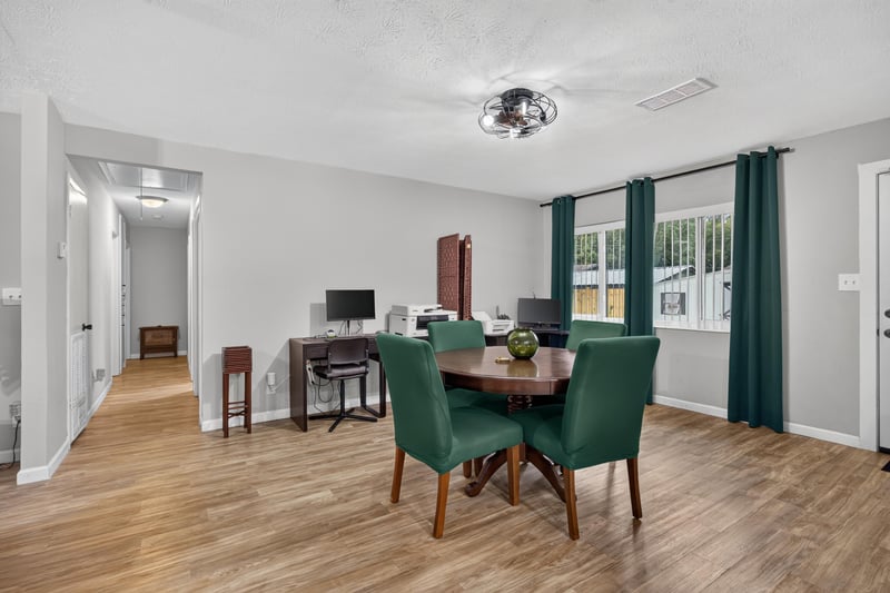 Dining area with round table and hallway view at 9506 Harriet Ave, Jacksonville, FL 32208