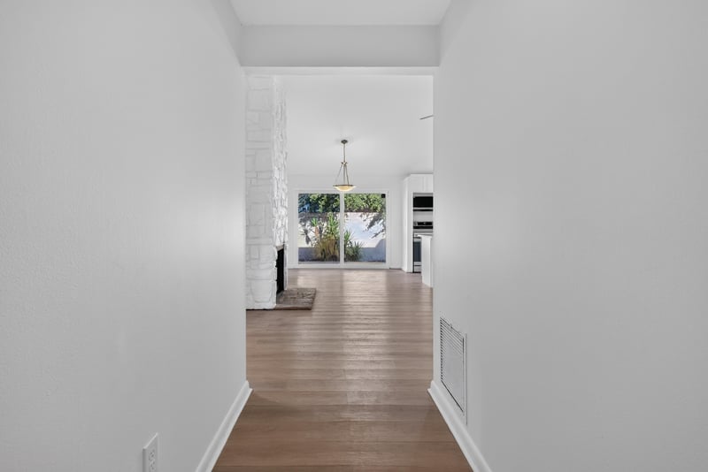 Entry hallway with wood-look flooring at 8177 Virgo St, Jacksonville, FL 32216