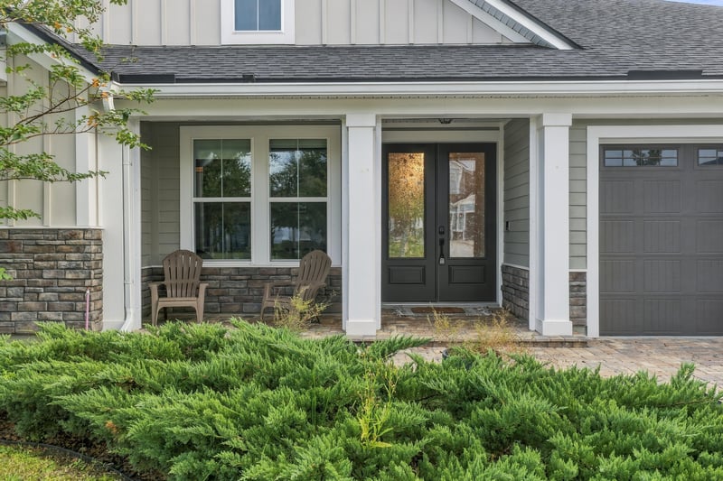 Covered front porch with columns and double doors at 3921 Spyglass Hill Ln