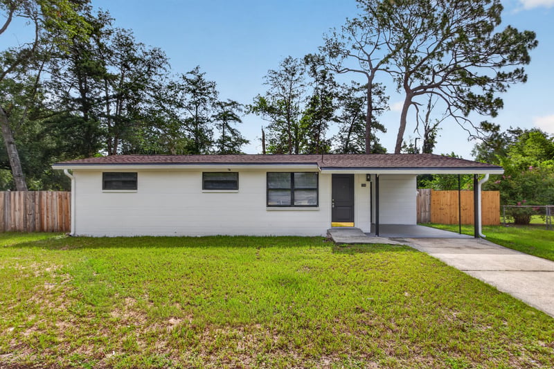 Front exterior, driveway and shaded front lawn at 184 Draco St, Orange Park, FL 32073