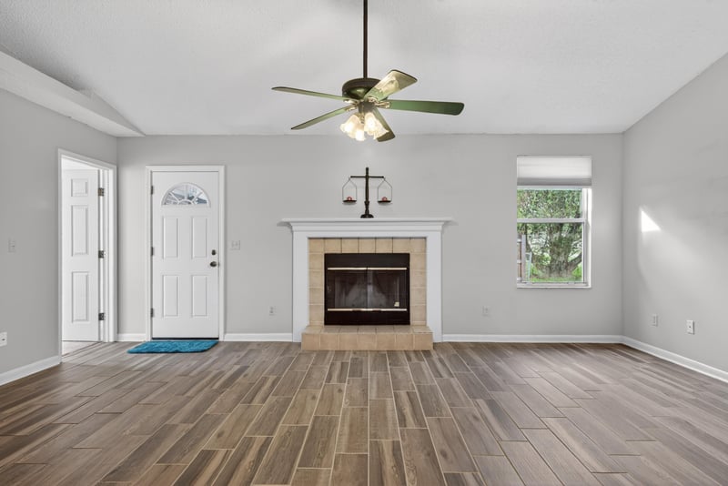 Living room with fireplace and ceiling fan at 2164 Orangewood St, Middleburg, FL 32068