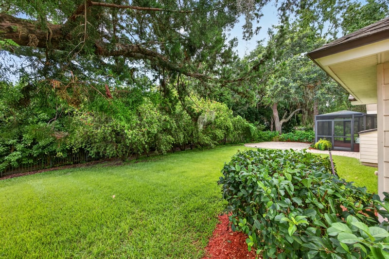 Backyard lawn with mature trees at 1955 GUARDED Way, Fleming Island, FL 32003