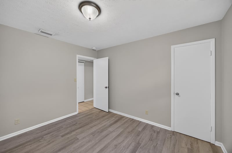 Room with wood-look flooring and closet doors at 5527 Beney Rd, Jacksonville, FL 32207