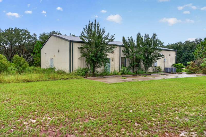 Exterior view of the second building with landscaping at 1038 County Rd 315, Melrose