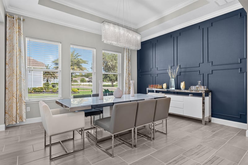 Dining room with navy accent wall and table seating at 22 Azura Point