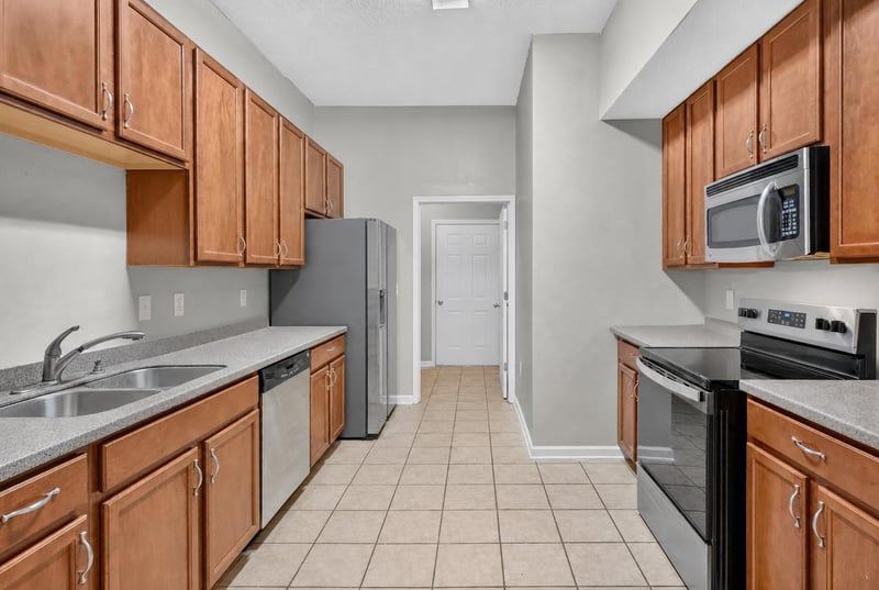 Kitchen with wood cabinets and tile flooring at 8196 Cabin Lake Cir, Jacksonville, FL 32256