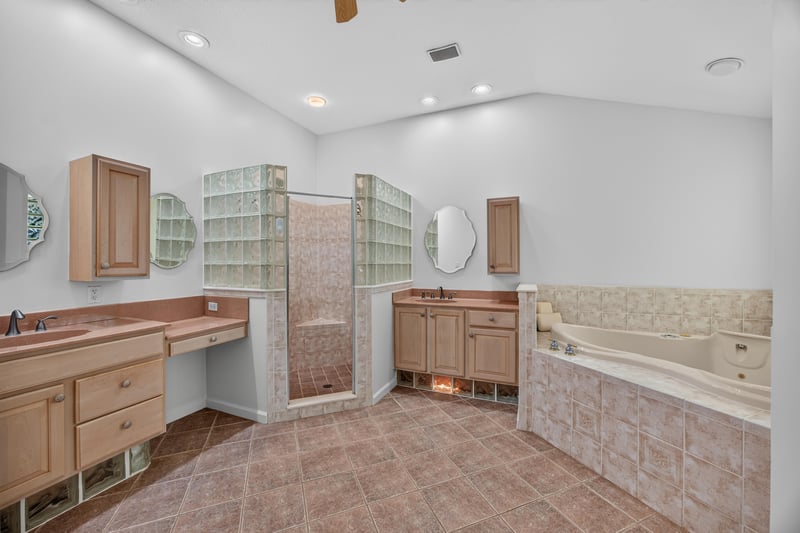 Primary bath with glass block window and garden tub at 11675 Magnolia Estates Rd, Jacksonville, FL 32223