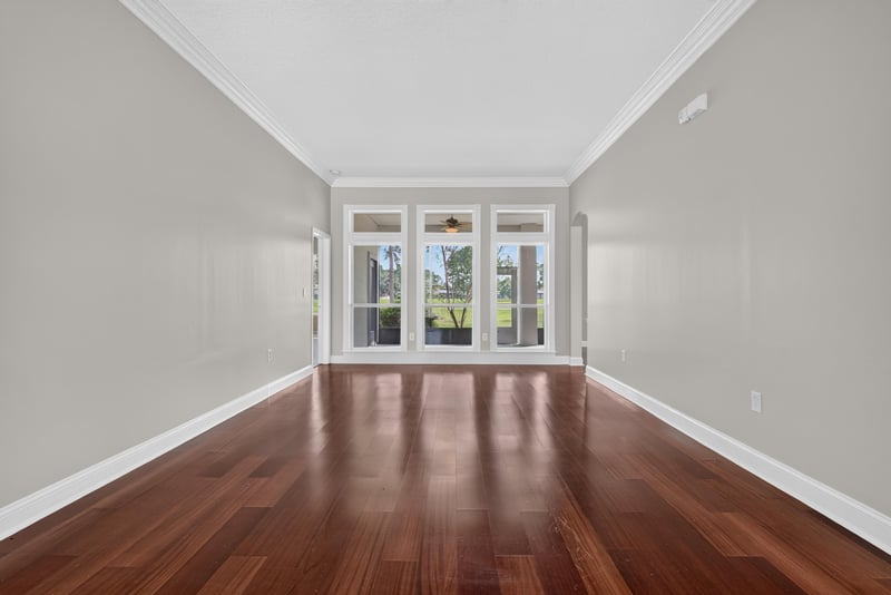 Living room with wood floors and large windows at 4109 Eagle Landing Pkwy, Orange Park, FL 32065