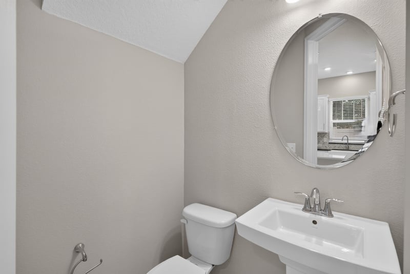 Bathroom with round mirror and sink at 7446 Loggerhead Ct, Jacksonville, FL 32256