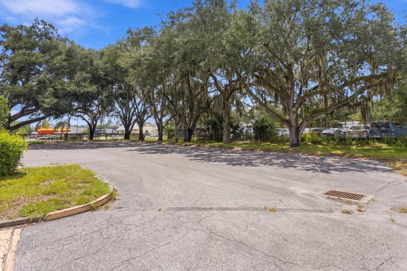 Parking lot and oak-lined street view at 101 Scholars Wy