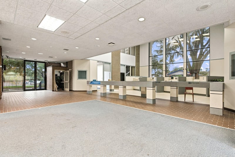 Open office area with service counters and windows at 101 Scholars Wy